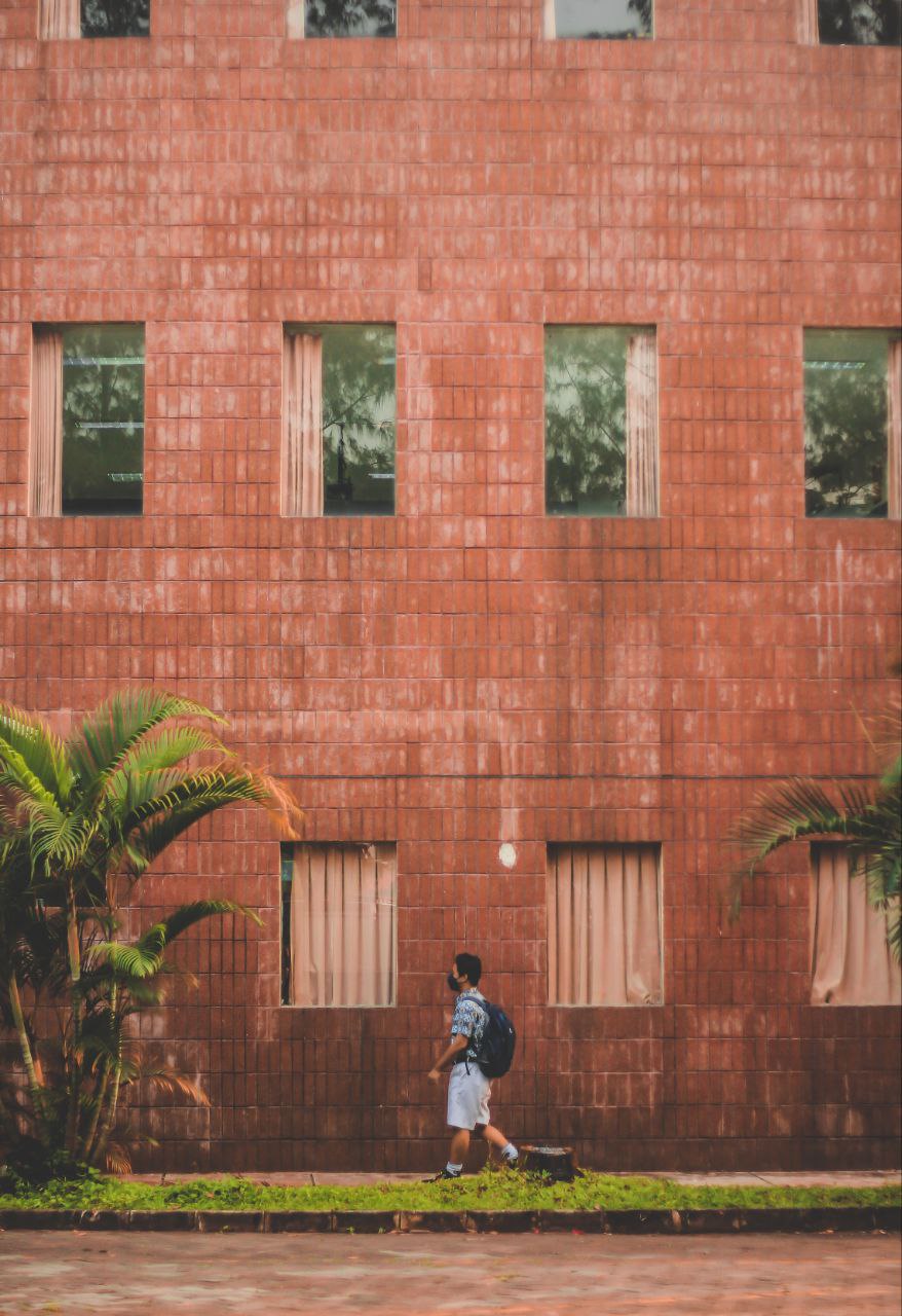 a person walking in front of a brick building